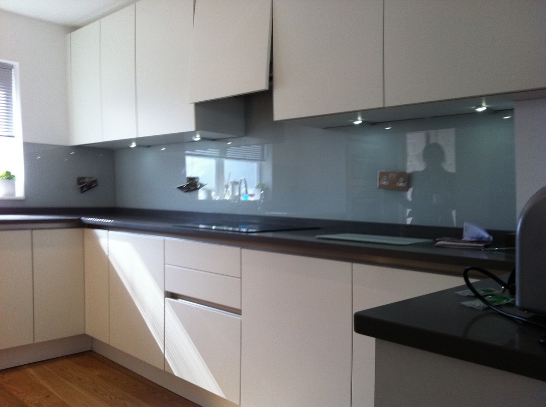 Grey glass kitchen splashback with LED lighting in Hackney
