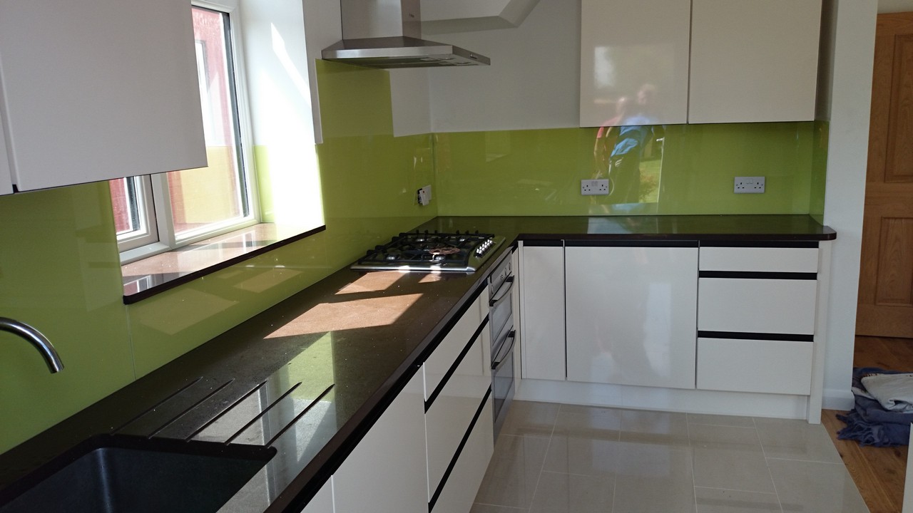 Lime green glass kitchen splashback installed by Hackney glaziers