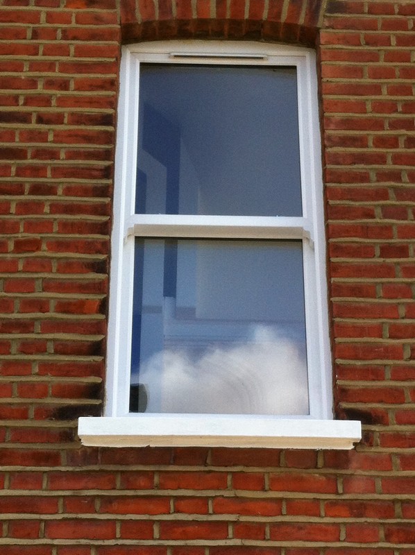 uPVC sash window on Victorian red brick house in Hackney